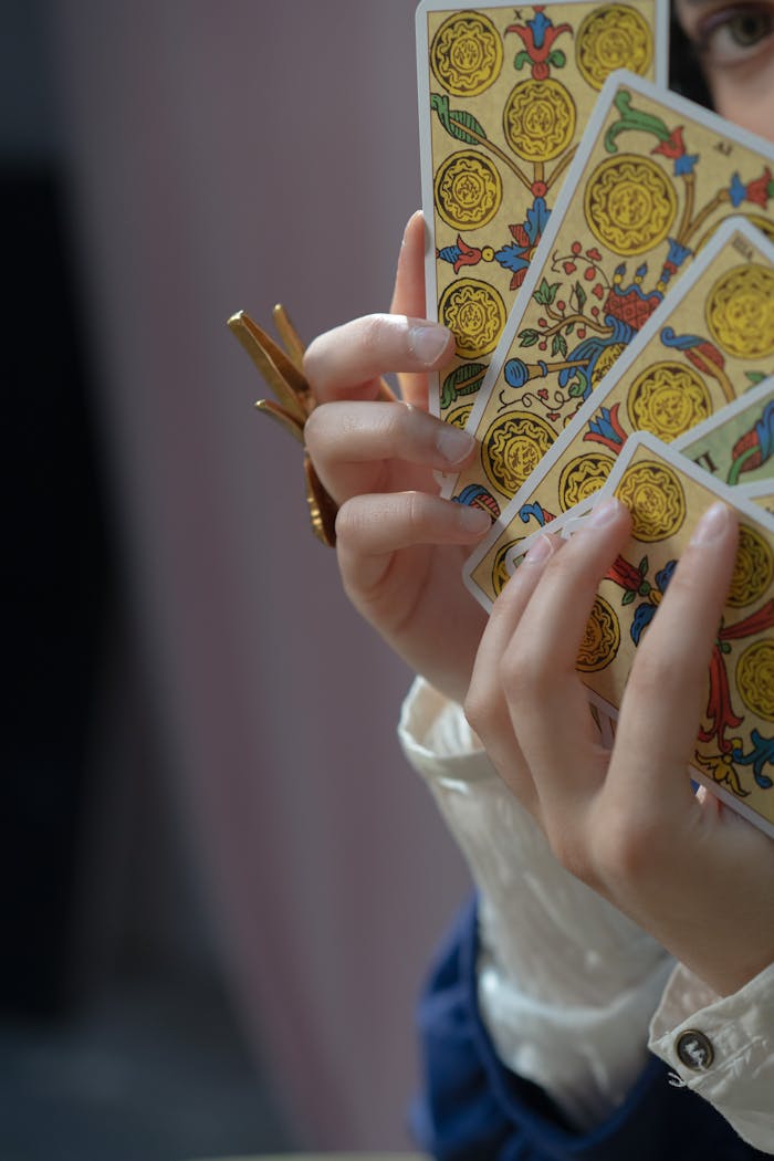 Close-Up Shot of a Person Holding Tarot Cards